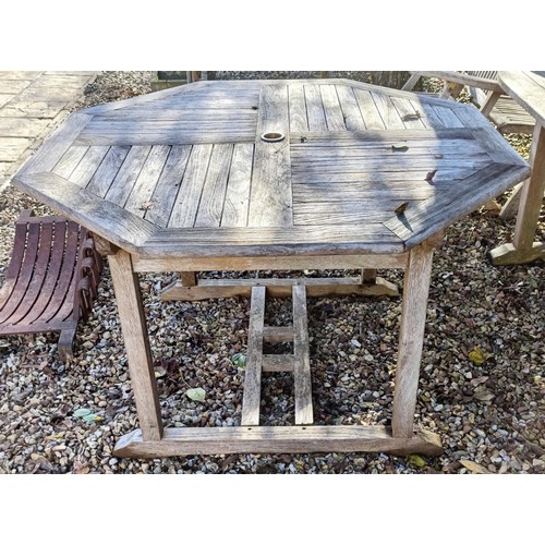 1431 - A garden teak octagonal folding table, and another similar (2)