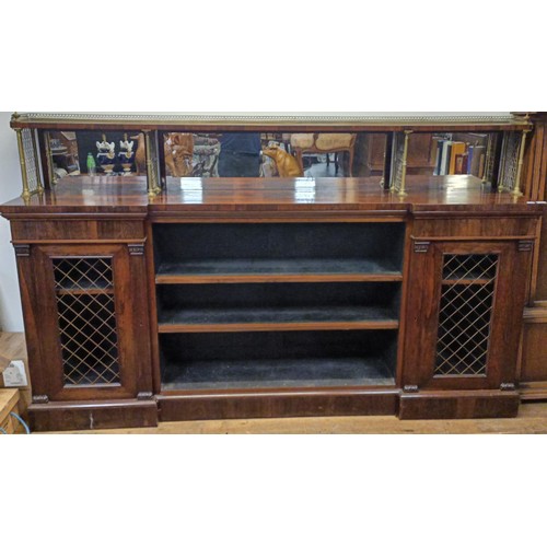 1274 - A late Regency rosewood inverted breakfront bookcase, with a mirrored superstructure raised on metal... 