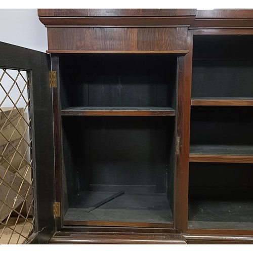 1274 - A late Regency rosewood inverted breakfront bookcase, with a mirrored superstructure raised on metal... 