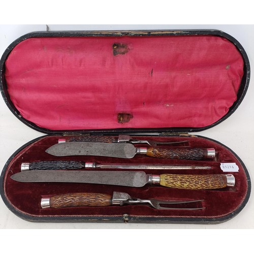 1148 - An antler mounted carving set, with silver collars, cased