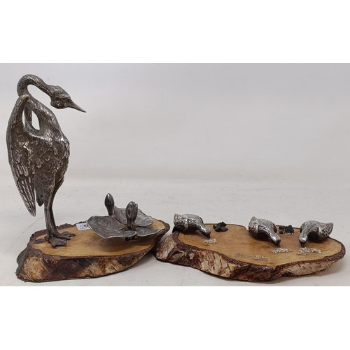 1149 - A figure of a crane with lily pads, on an associated wood base, and another similar group (2)