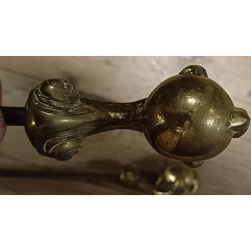 1163 - A set of three brass fire irons, with claw and ball finials, the tongs 68 cm