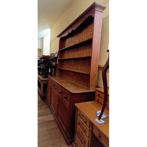 1314 - A late 19th century pine dresser, the three tier plate rack on a base with three drawers and three c... 