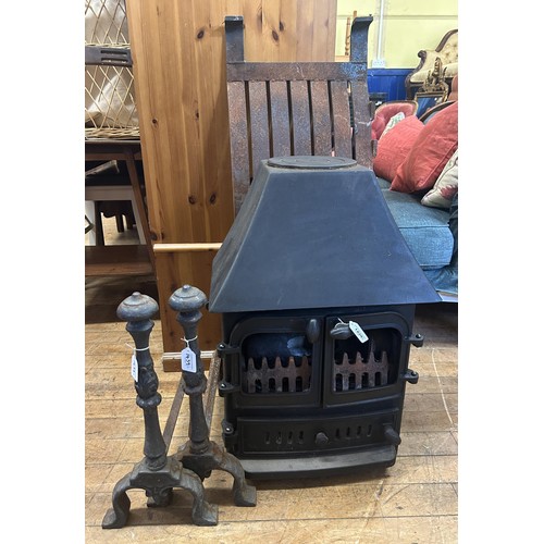 1439 - A wood burning stove, a pair of fire dogs and a fire grate (4)...