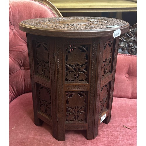 1370 - An Indian carved folding table, 38 cm diameter