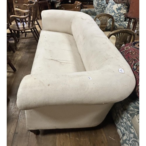 1287 - A Victorian Howard style Chesterfield settee, in need of upholstering, on turned front legs, 206 cm ... 