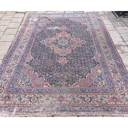 1281 - A large Persian style carpet, heavily worn, 477 cm x 326 cm