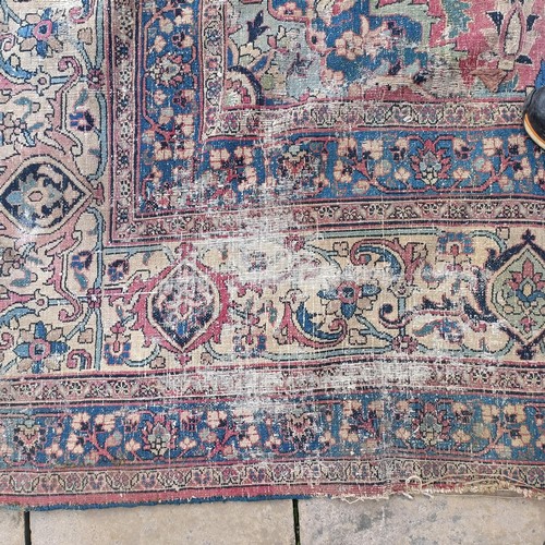 1281 - A large Persian style carpet, heavily worn, 477 cm x 326 cm