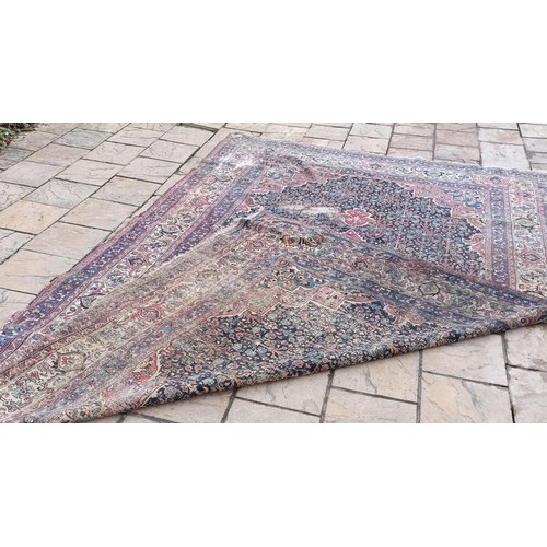 1281 - A large Persian style carpet, heavily worn, 477 cm x 326 cm