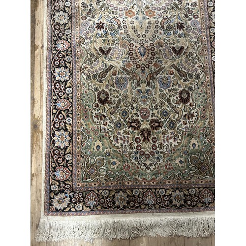 1296 - A Persian silk cream ground rug, with floral decoration, 157 x 92 cm