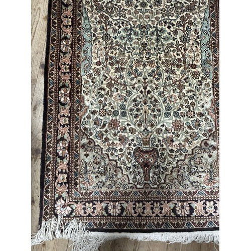 1297 - A Persian silk ground red ground rug, with floral decoration, 123 x 78 cm