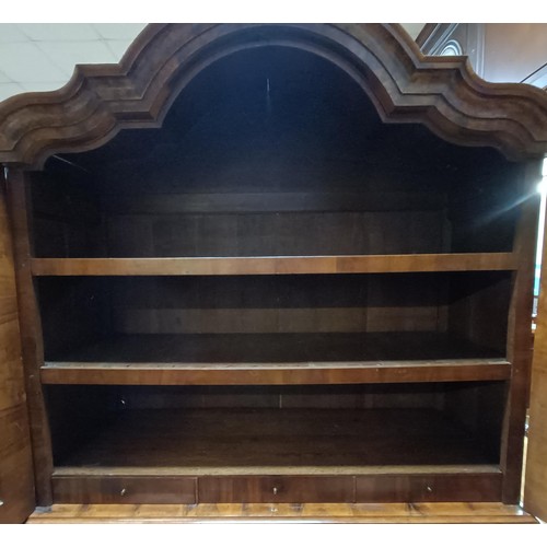 1275 - A large and impressive Dutch walnut armoire, the top having two shaped doors, to reveal shelves and ... 