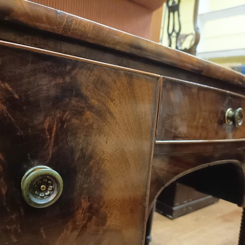 1367 - A 19th century mahogany bow front kneehole dressing table, having three drawers, on ring turned tape... 