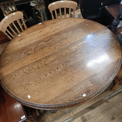 1265 - A late 19th century oak extending dining table, inset a (later) leaf, on a base carved mythical beas... 