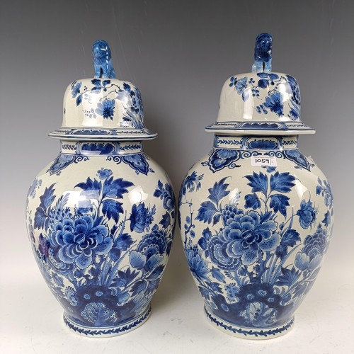 1059 - A near pair of blue and white Delft vases and covers, 55 cm high (2)