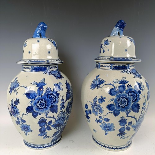 1059 - A near pair of blue and white Delft vases and covers, 55 cm high (2)