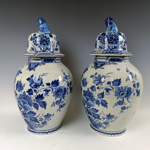 1059 - A near pair of blue and white Delft vases and covers, 55 cm high (2)