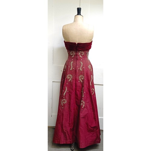 7 - A vintage female mannequin, on a metal tripod base, 170 cm high, and a red evening dressProvenance: ... 