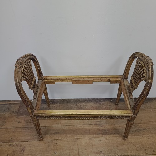 765 - An early 20th century gilt window seat, with pierced ends, on reeded tapering legs, 86 cm wide