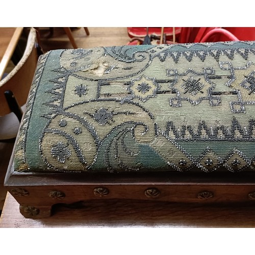 103 - A 19th century footstool, with a beadwork top, 124 cm wide