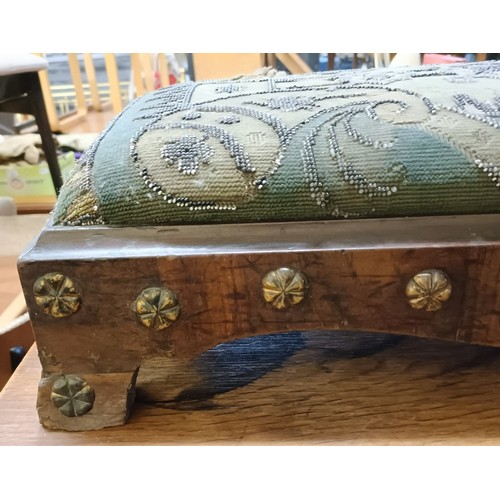 103 - A 19th century footstool, with a beadwork top, 124 cm wide