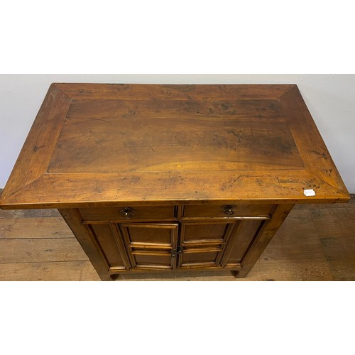 714 - A Chinese elm side cupboard, having two drawers and two cupboard doors, 112 cm wide