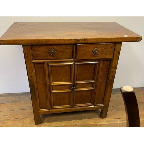 714 - A Chinese elm side cupboard, having two drawers and two cupboard doors, 112 cm wide