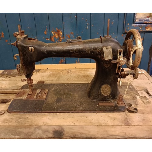 87 - A Liscot sewing machine, on an iron treadle base, barn stored , 90 cm wide Provenance:  A single own... 