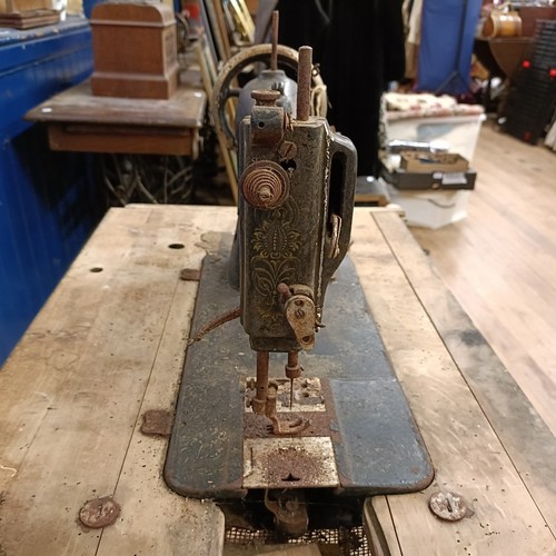 87 - A Liscot sewing machine, on an iron treadle base, barn stored , 90 cm wide Provenance:  A single own... 