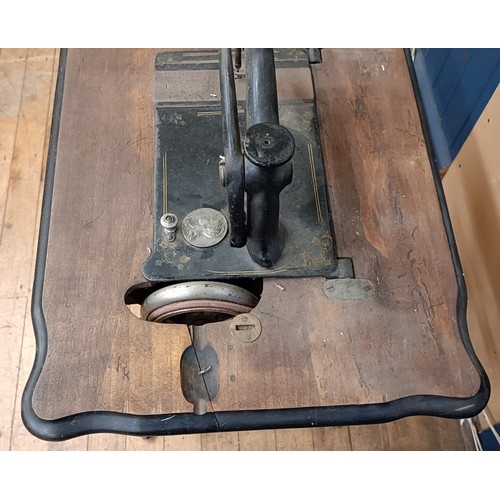 82 - A Peugeot Audincourt sewing machine, on an iron treadle base, 80 cm wide Provenance:  A single owner... 