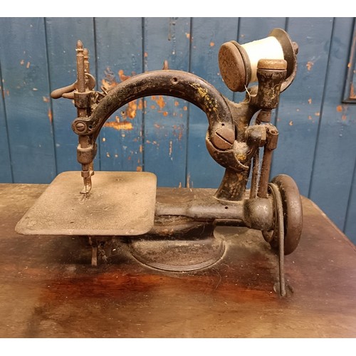 81 - A Willcox & Gibbs automatic silent sewing machine, on an iron treadle base, 50 cm wide Provenanc... 