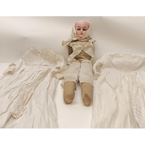 128 - Assorted christening gowns, and a bisque head doll