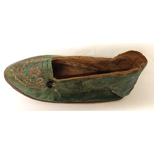 138 - A pair of Chinese childs leather and silk embroidered shoes