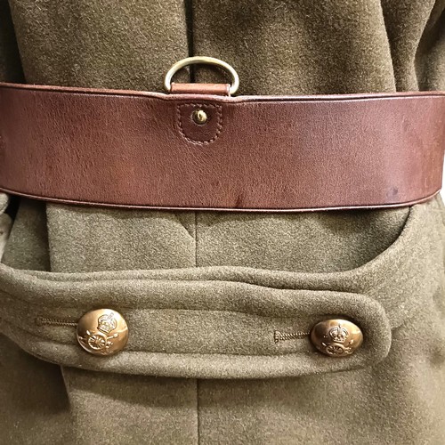 38 - A military coat, a leather belt and assorted military hats (box) Provenance:  A single owner collect... 