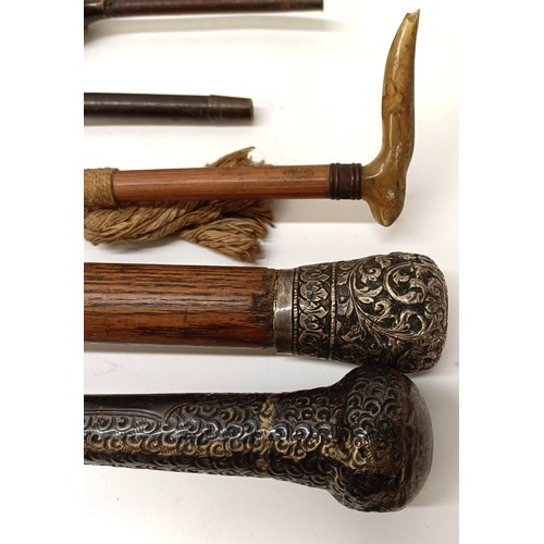 54 - A late 19th/early 20th century parasol, assorted walking sticks and umbrellas (8) Provenance:  A sin... 