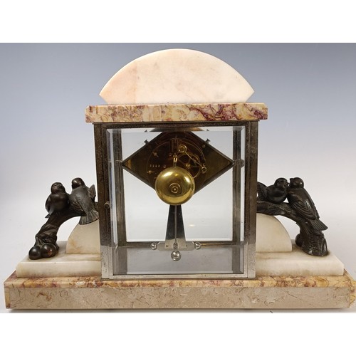 418 - An Art Deco mantel clock, with a lozenge shaped dial, in a marble, spelter and glass case, 37 cm hig... 