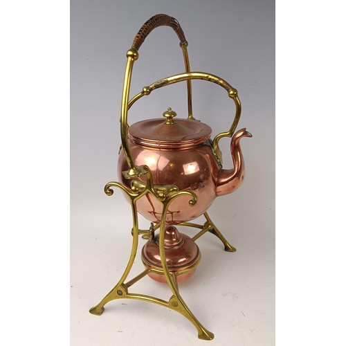 423 - An Arts and Crafts style copper kettle on a stand, 35 cm