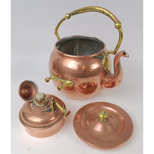 423 - An Arts and Crafts style copper kettle on a stand, 35 cm