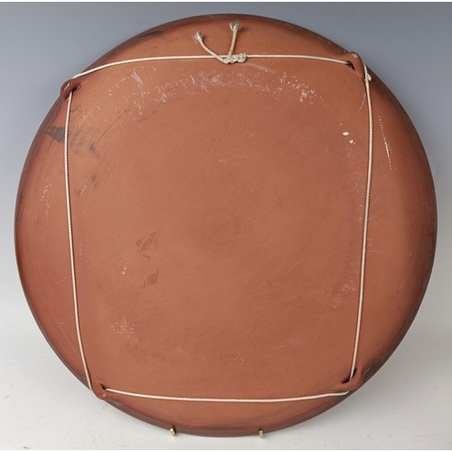 428 - An earthenware charger, decorated peaches and flowers, 42 cm diameter