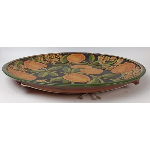 428 - An earthenware charger, decorated peaches and flowers, 42 cm diameter