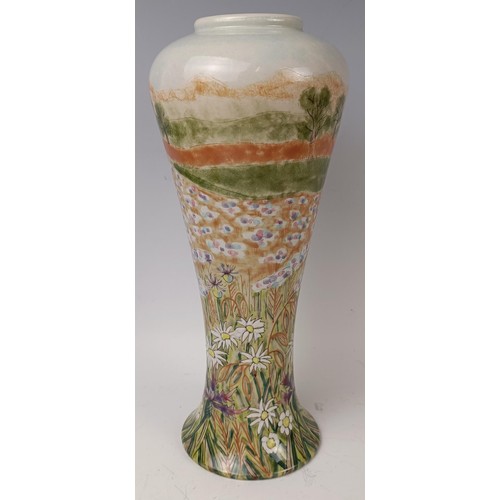 437 - A Cobridge stoneware limited edition vase, 13/250, decorated flowers, 32 cm high