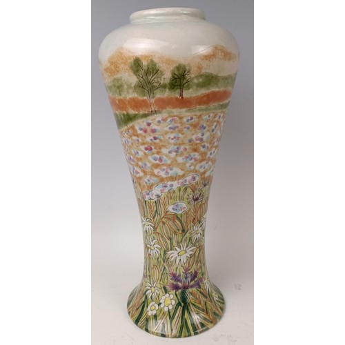 437 - A Cobridge stoneware limited edition vase, 13/250, decorated flowers, 32 cm high