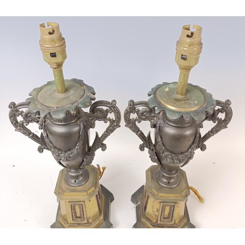 514 - A pair of bronze and gilt bronze lamp bases, in the form of urns, 42 cm high (2)