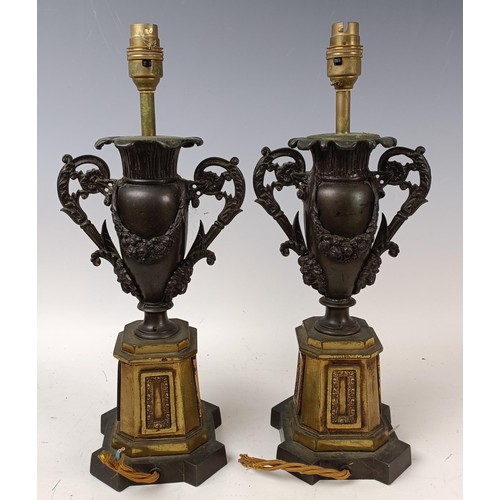 514 - A pair of bronze and gilt bronze lamp bases, in the form of urns, 42 cm high (2)