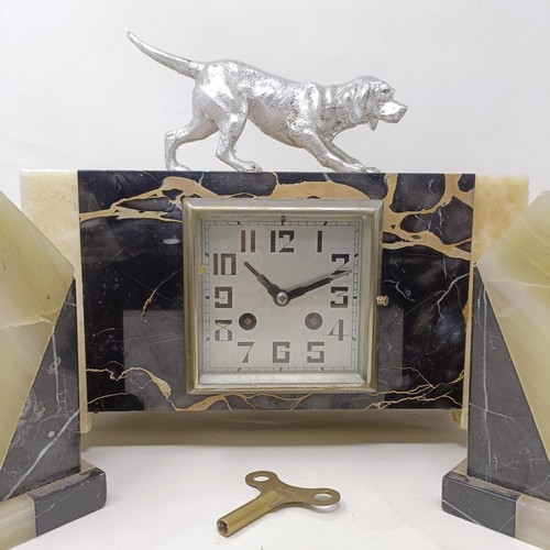 436 - An Art Deco clock garniture, the clock with a dog finial, 30 cm wide (3)