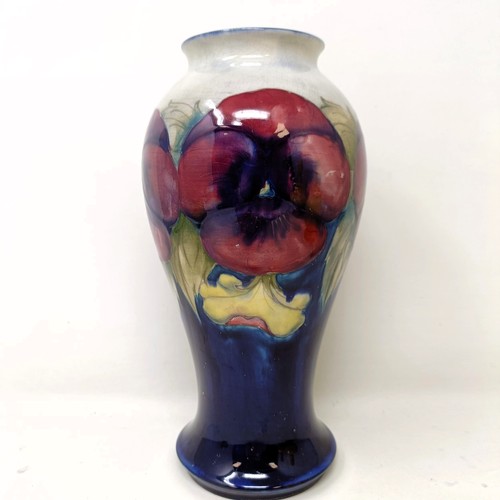 411 - A Moorcroft pottery vase, of baluster form, decorated pansies, 23 cm high