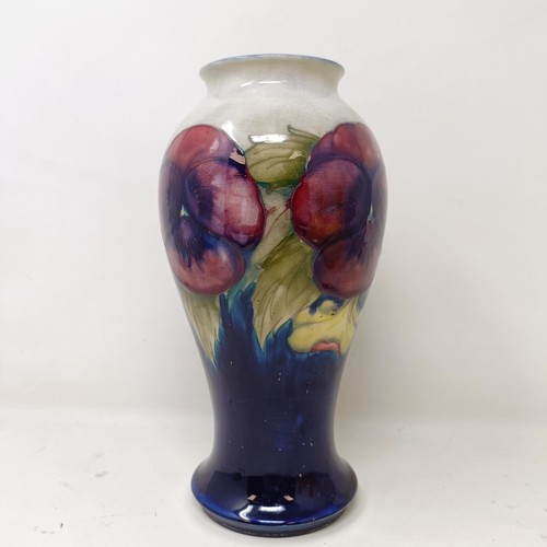 411 - A Moorcroft pottery vase, of baluster form, decorated pansies, 23 cm high