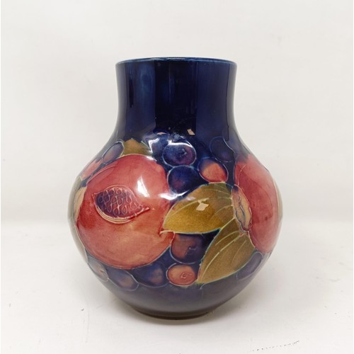 413 - A Moorcroft pottery vase, decorated pomegranates, 14 cm high