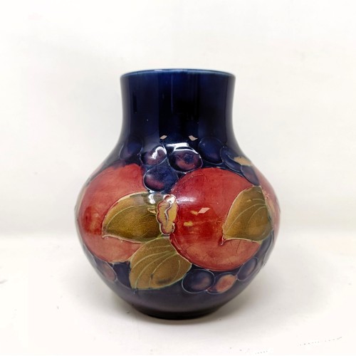 413 - A Moorcroft pottery vase, decorated pomegranates, 14 cm high