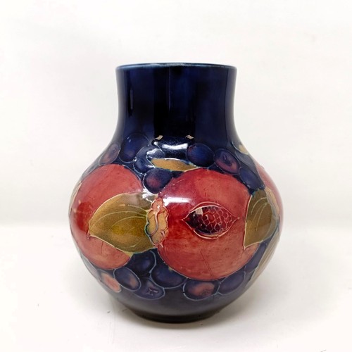 413 - A Moorcroft pottery vase, decorated pomegranates, 14 cm high